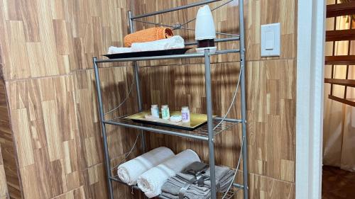a towel rack in a bathroom with towels on it at Odyssey Suites Loft Apartment in Georgetown