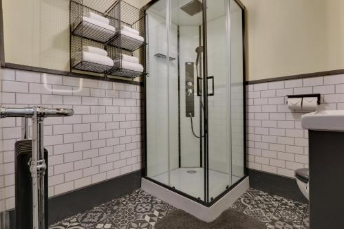a bathroom with a glass shower and a toilet at Derbyshire Chapel for 6 at Harthill Hall private hot tub 8am - 10pm plus private daily use of indoor pool and sauna 1 hour in Stanton in Peak