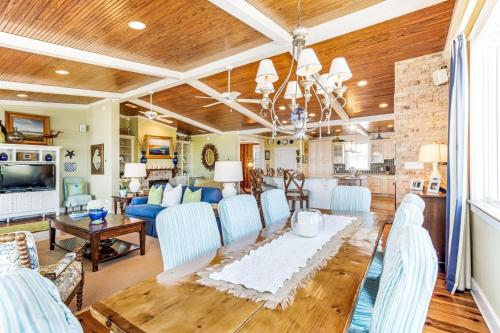 a living room with a blue couch and a table at Tenth Street Retreat in Tybee Island