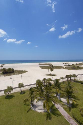an aerial view of a beach with palm trees at South Beach Oceanfront Resort in St. Pete Beach