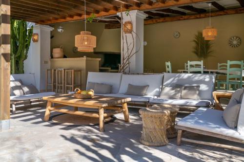 a patio with a couch and a table and chairs at Valley Club Ibiza - Boutique Agroturismo in Sant Joan de Labritja