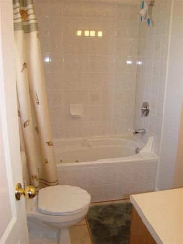 a bathroom with a toilet and a bath tub at Tucked Inn the Harbour B&B in Victoria Harbour