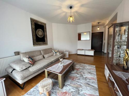 a living room with a couch and a table at Lucky Apartments II in Pristina