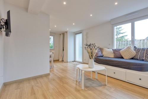 a living room with a couch and a table at La Dune de Sable Sainte Marguerite in Pornichet