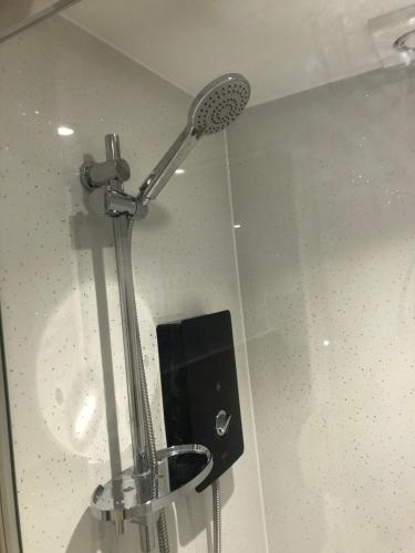 a shower in a bathroom with a shower head at The Annexe Bedford in Bedford