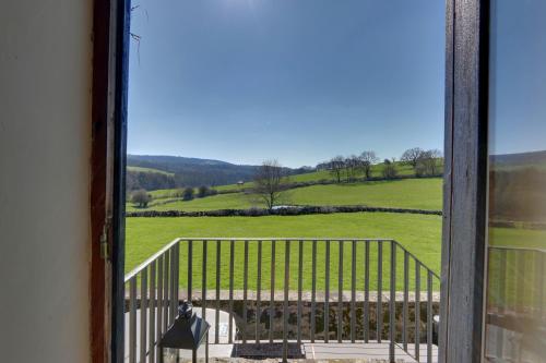 a view of a green field from a window at Priesthill HotTub Pool Dog Friendly PeakDistrict in Stanton in Peak