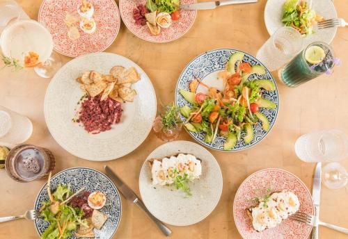 a table with plates of food on it at Wyndham Palmas Beach and Golf Boutique Resort in Humacao