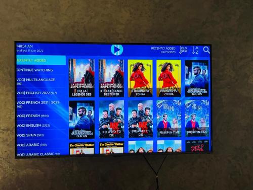 a television screen with a bunch of movies on it at Corniche apartments in Casablanca