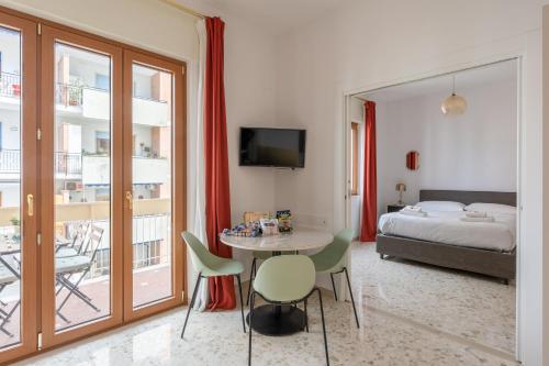 een kamer met een tafel en stoelen en een bed bij I Sogni della Regina in Sorrento