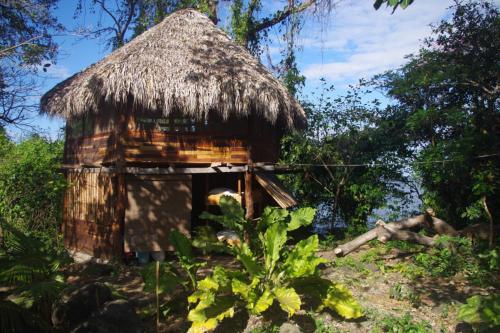 a small hut with a straw roof at El Pital, Chocolate Paradise in Balgue
