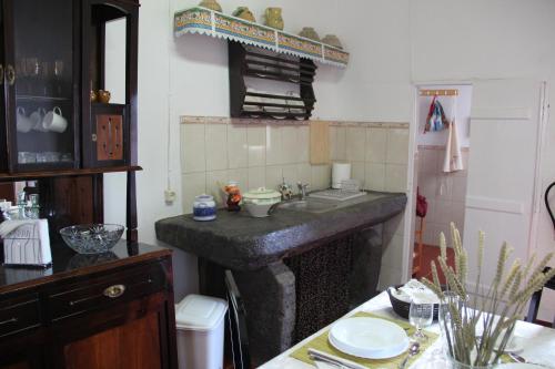 a kitchen with a sink and a counter top at Casa do Sr. Alberto in Praia da Vitória