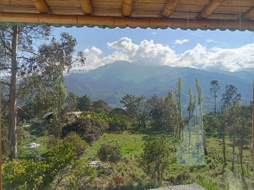 a view of a mountain view from a house at HOSTAL CASA DE GUADUA/ THE BAMBOO HOUSE in Choachí