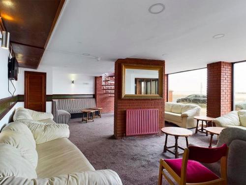 a living room with couches and a mirror at Jini Hotel in Blackpool