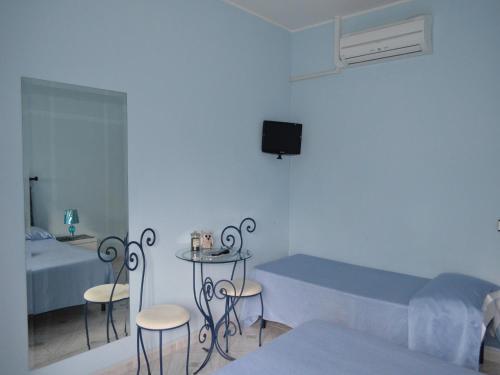 a room with a bed and a table and chairs at A Casa di Carla in Terni