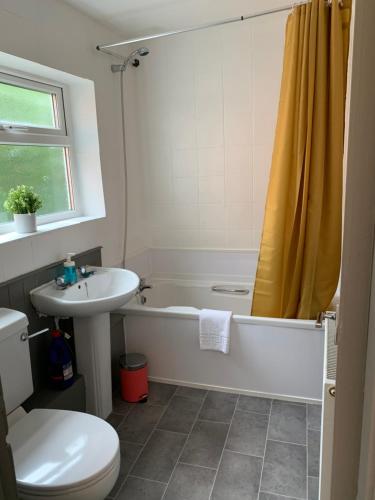 a bathroom with a tub and a toilet and a sink at Balfour - Beautiful refurbished spacious 3 bedroom Gateshead flat in Gateshead