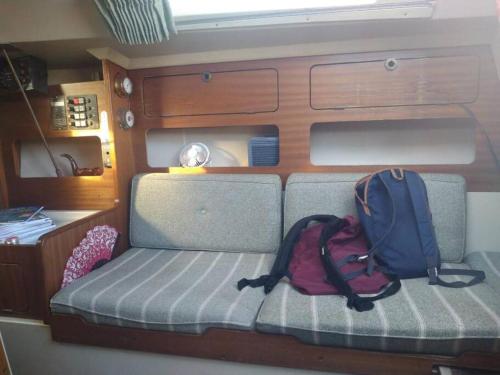 two backpacks are sitting on a couch in an rv at super Voilier Eve in Gruissan