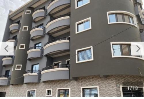 a large building with balconies on the side of it at Appartement meublé à Saint-Louis in Saint-Louis