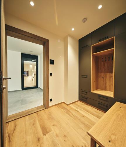 an empty kitchen with a wooden table and a door at Aldrov Resort in Vítkovice
