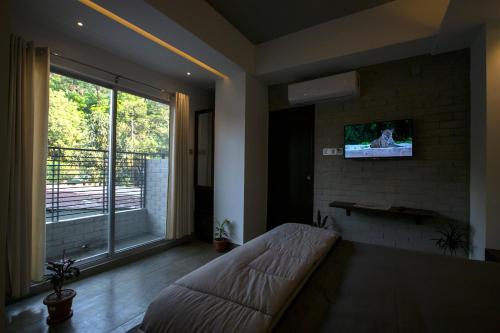 a living room with a couch and a large window at Rahma’s B&B in Sylhet