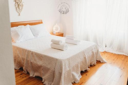a bedroom with a bed with two towels on it at Casa Manjerico in Loulé