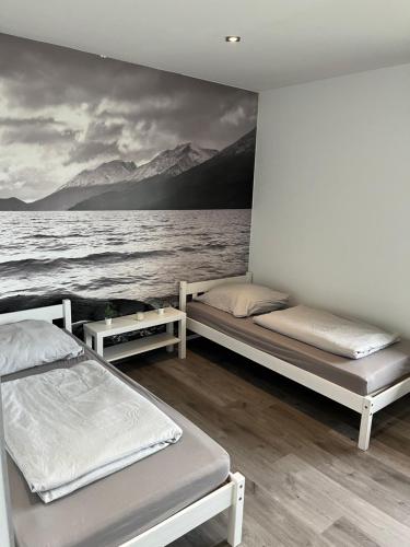 two beds in a room next to a body of water at Messewohnung/Ferienwohnung in Cologne