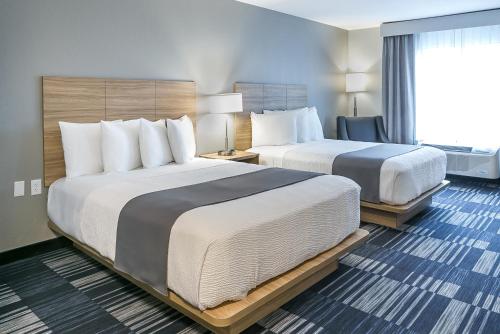 a hotel room with two beds and a window at Winds Hotel at Crosswinds Casino in Park City