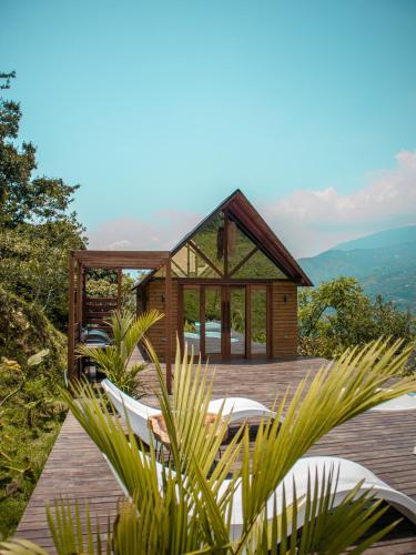 a wooden deck with chairs and a gazebo at All Natural Glamping in Copacabana