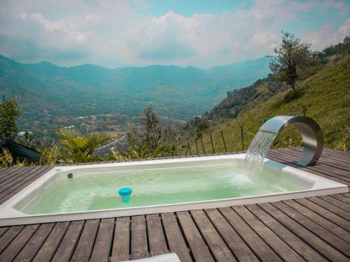 a hot tub with a water fountain on a wooden deck at All Natural Glamping in Copacabana