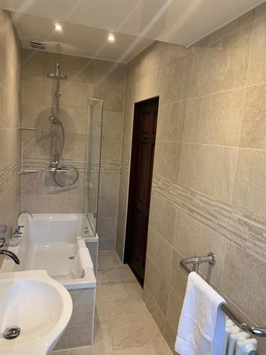 a bathroom with a tub and a sink and a shower at Rodsley - 2 bedroom 1st floor flat Free Parking WiFi and Netflix in Gateshead