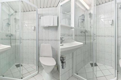a white bathroom with a toilet and a sink at Havly Hotell in Stavanger