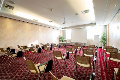 an empty room with chairs and a podium at Etrusco Arezzo Hotel - Sure Hotel Collection by Best Western in Arezzo