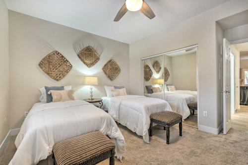 a bedroom with two beds and a large mirror at Scottsdale Condo Pool, Hot Tub and Grill Access! in Scottsdale