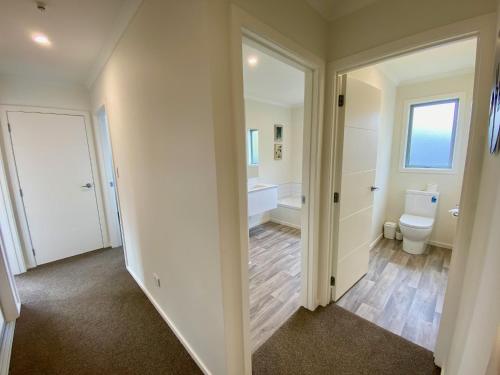 a bathroom with a toilet and a sink at Relax, Refresh, Recharge in Twizel