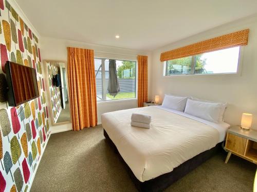 a bedroom with a large bed and a window at Relax, Refresh, Recharge in Twizel