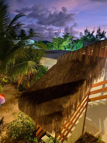 a thatched roof on a building with a river at Pousada Águas de Tamandaré in Tamandaré