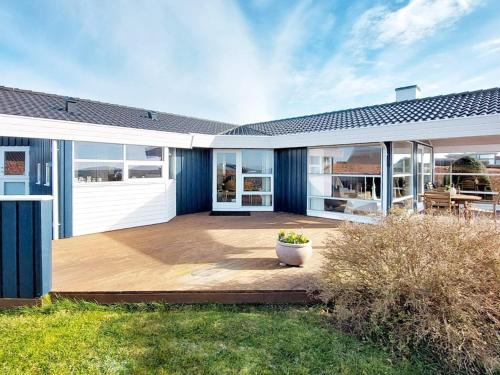 a house with a large patio with a yard at 6 person holiday home in Karrebæksminde-By Traum in Karrebæksminde