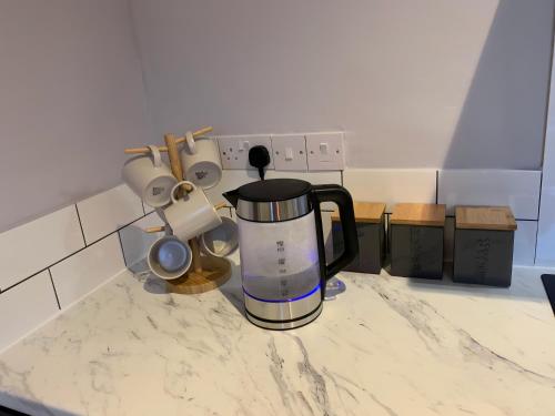 a coffeemaker on a kitchen counter with spices at Heaton-Beautiful 3 Double Bedrooms Sleeps 6 Free Parking and Wifi in Newcastle upon Tyne