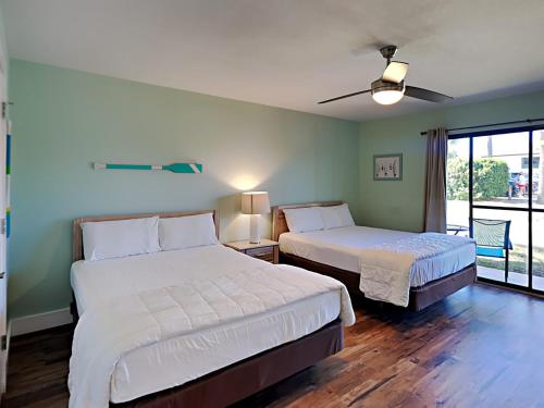 a bedroom with two beds and a window at Edgewater Villa #2406 in Panama City Beach