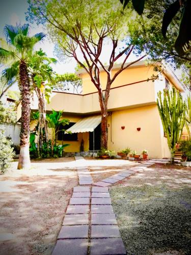 a building with palm trees in front of it at Villa Regina in Fort Village