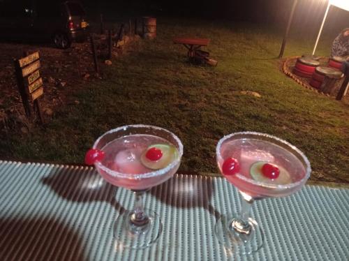 two wine glasses with fruit in them on a table at Camping Las Acacias in Guatavita