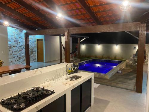 a kitchen with a swimming pool in the background at Casa Ametista in Pirenópolis