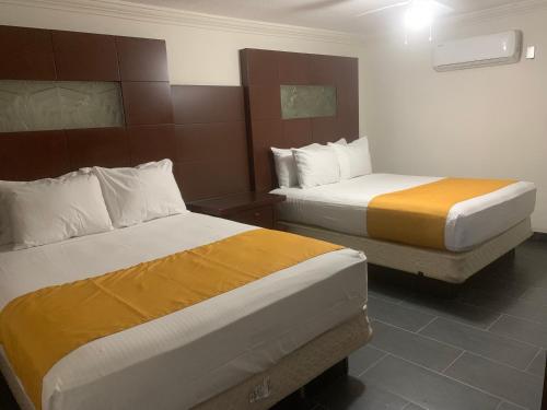ein Hotelzimmer mit 2 Betten in einem Zimmer in der Unterkunft HOTEL DORADO DIAMANTE in Mexicali