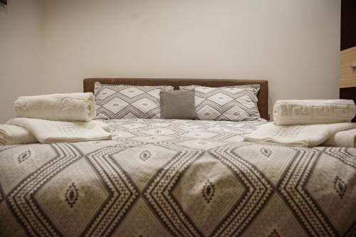 a large bed with two pillows on top of it at Studio Unikat in Braşov
