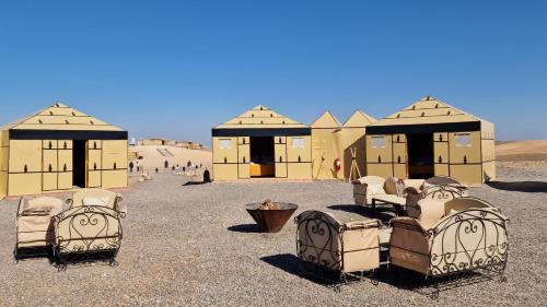 a group of chairs in the middle of the desert at Nkhila Lodge in Marrakech