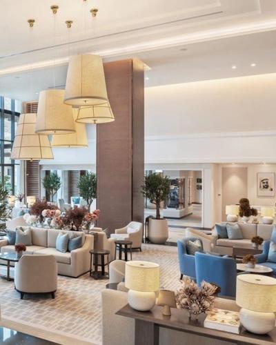 a living room with couches and chairs in a building at Address beach resort fujairah in Ḩaqīl
