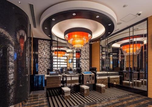 a lobby of a store with chandeliers and tables at APA Hotel Omori Ekimae in Tokyo