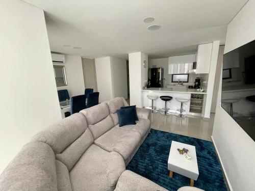 sala de estar con sofá y cocina en Moderno y cómodo apartamento en Puerta del Sol en Bucaramanga