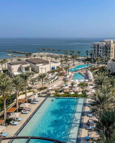 an aerial view of a resort with a swimming pool at Address beach resort fujairah in Ḩaqīl