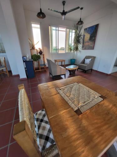a living room with a wooden table and chairs at Casa Puerto Bonito, Aparthotel & Coworking in Puerto Escondido