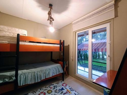 a bedroom with a bunk bed and a window at bungalov ve göl kenarina kurulmuş sahil evi. 